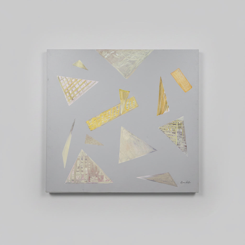An abstract geometric painting on a square canvas, featuring triangles and rectangular shapes in gold, beige, and gray tones against a gray background, hung on a white wall.