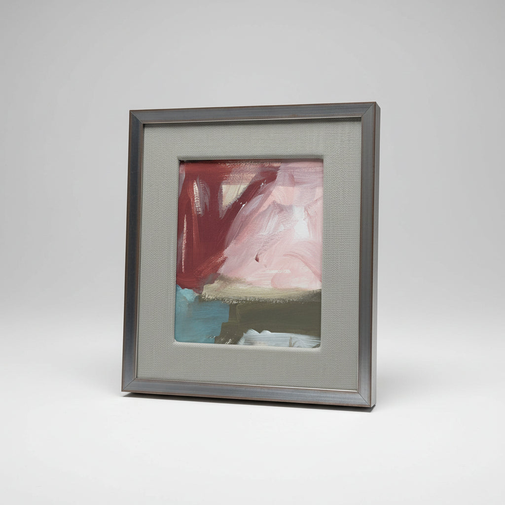 A framed artwork titled '#1361' by Daniel Van Osten, featuring a blend of red, blue, and beige colors on a white background, displayed on a wooden surface in a home environment.