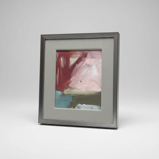A framed artwork titled '#1361' by Daniel Van Osten, featuring a blend of red, blue, and beige colors on a white background, displayed on a wooden surface in a home environment.