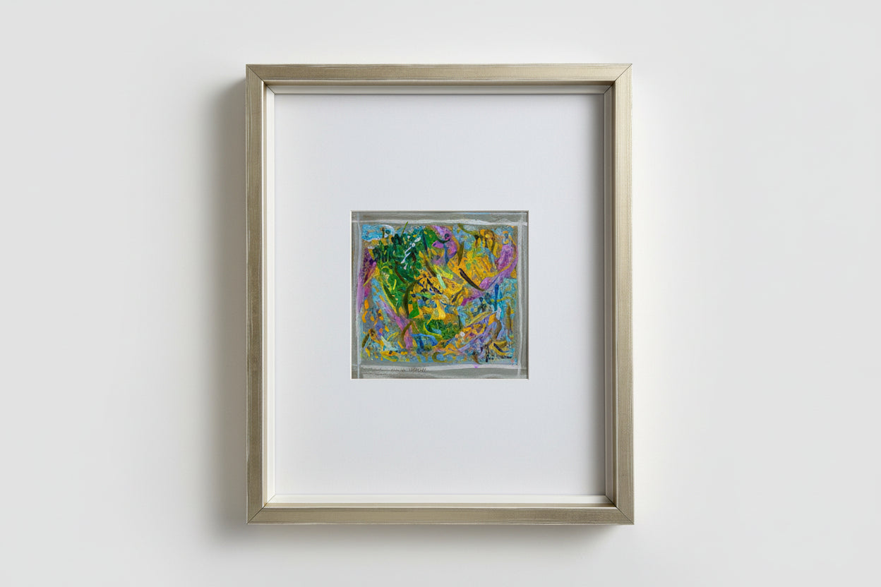 A custom framed artwork featuring a colorful, abstract scene, part of the Whimsy in Wonderland series, displayed on a wooden surface with a reflective background.