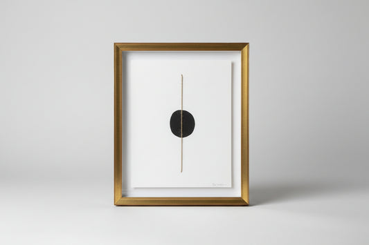 A framed artwork featuring a thin line drawing, displayed on a wooden surface with a blurred background.