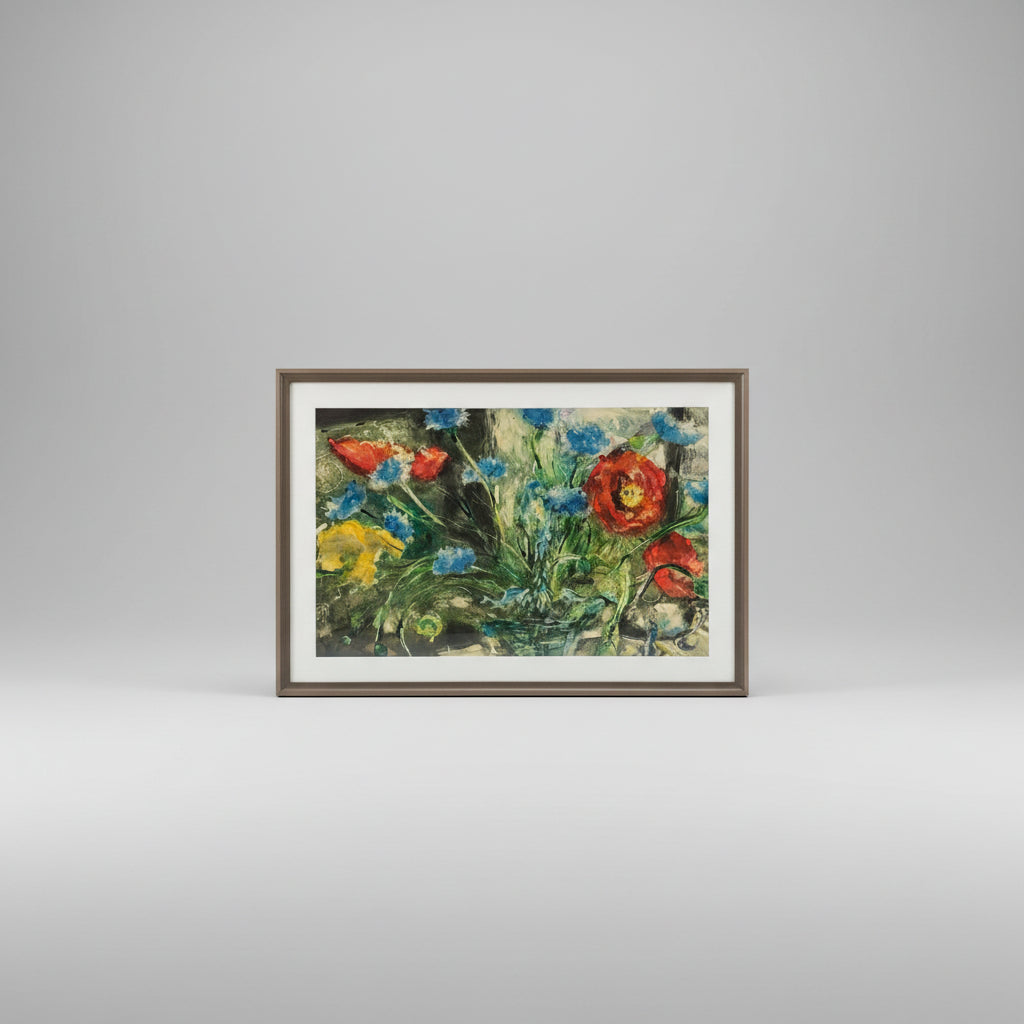 A framed mono print artwork featuring a vibrant floral composition, displayed on a wooden surface.