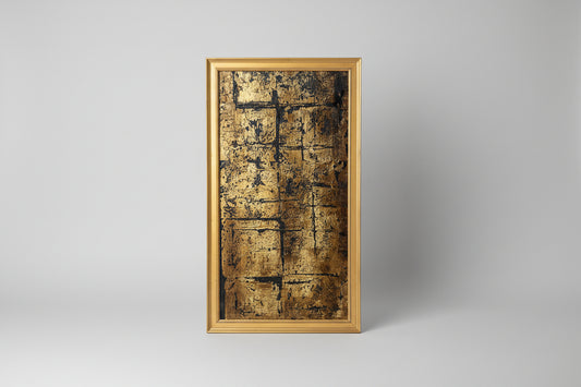 A canvas painting with a gold frame, displaying a textured gold surface, placed on a wooden surface with a mannequin head in the background.