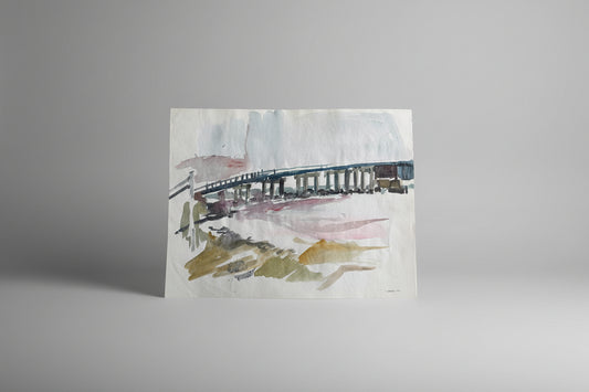A piece of artwork featuring a bridge over water, painted with watercolor and ink on paper, displayed against a neutral background.