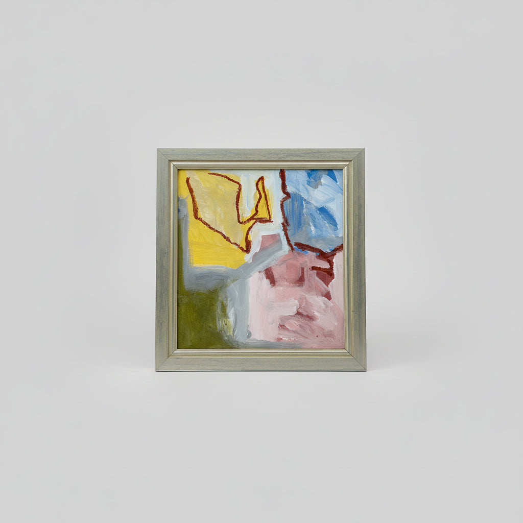 A framed abstract artwork titled 'Springtime Awakening' by Daniel Van Osten, displayed on a wooden surface with a blurred background.