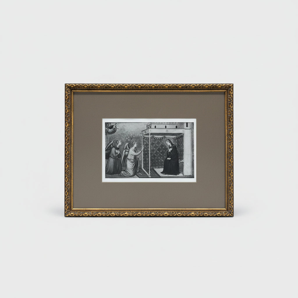 A framed etching titled 'The Virgin - #1383' displayed on a wooden surface, with intricate black artwork and a gold ornate frame.