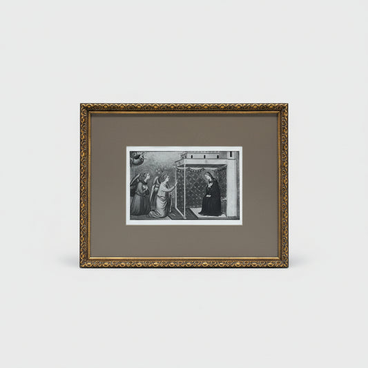 A framed etching titled 'The Virgin - #1383' displayed on a wooden surface, with intricate black artwork and a gold ornate frame.