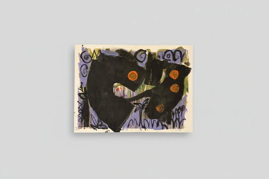 A mixed media artwork on paper titled 'Mecca 1' displayed on a wooden easel with a background of a white wall and a plant.
