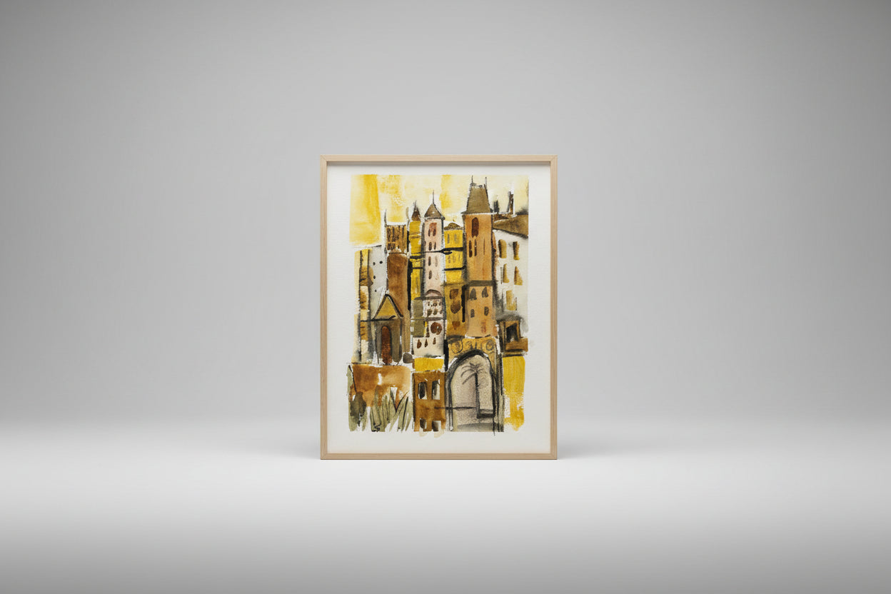 A mixed media artwork depicting a stylized cityscape with vibrant colors displayed on a paper, placed on a table with a plant and a window in the background.
