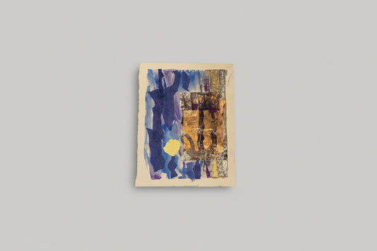 A mixed media collage on paper featuring a blue and purple abstract pattern with textures, displayed on a wall above a wooden bench with a plant and a decorative object.