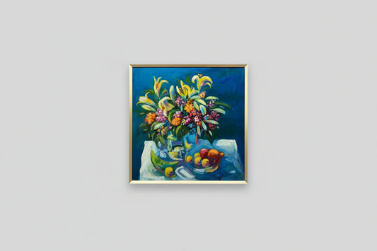 A framed artwork titled 'Flowers and Fruit' by Chris Zambone, depicting a vase of multicolored flowers and fruit on a table, displayed in a home setting with natural lighting.