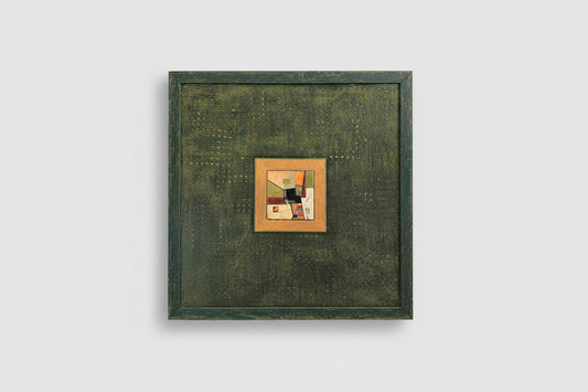 A custom distressed frame with a collage on board, hanging on a wall.