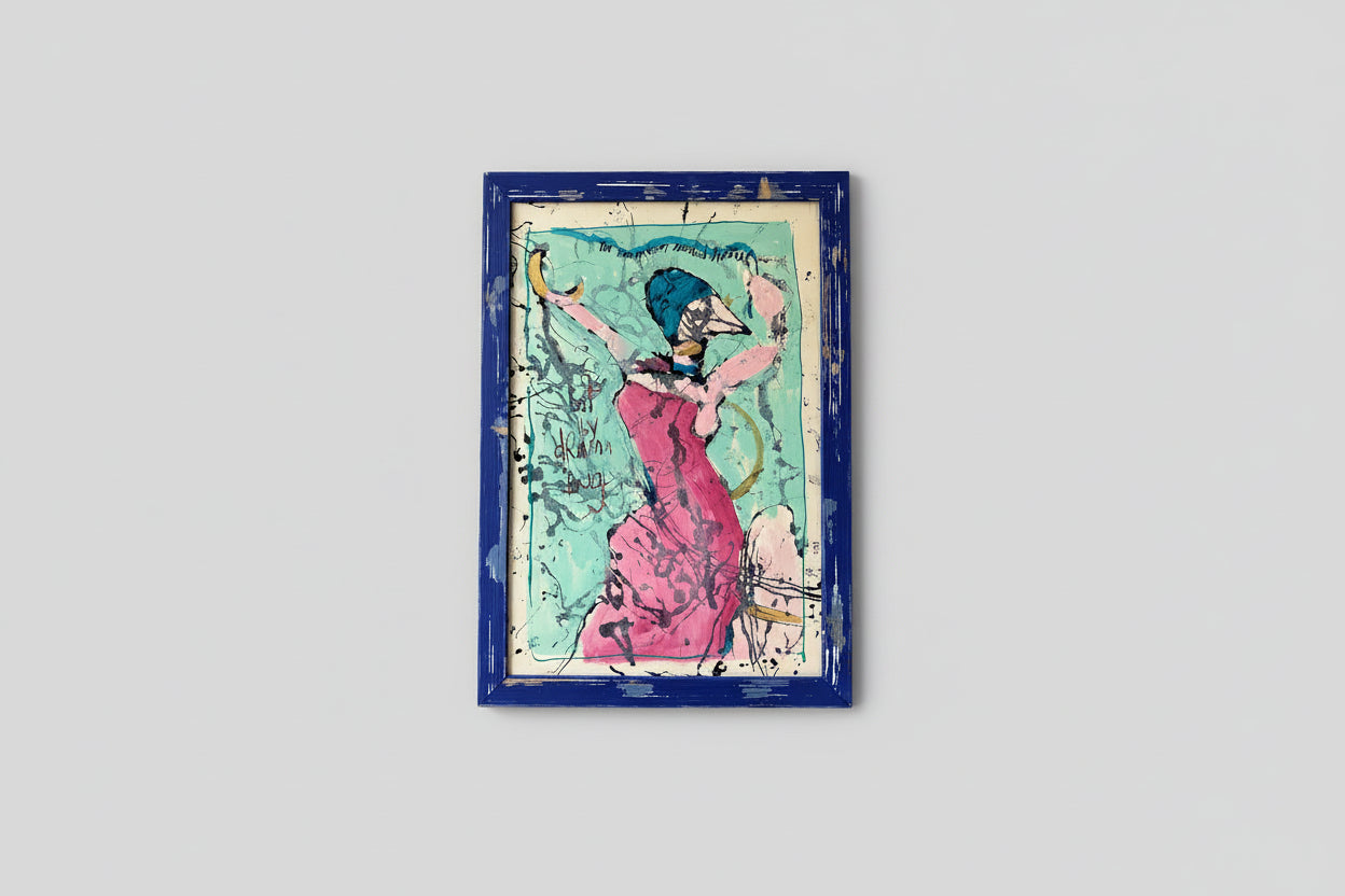 A mixed media artwork featuring a custom distressed frame, with a vibrant and colorful depiction of a female figure in a dramatic pose, hung on a wall above a wooden table in a well-lit room.