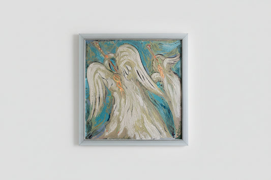 A framed artwork featuring an angel in a stained glass style, with a blue and white color palette, displayed on a wall.