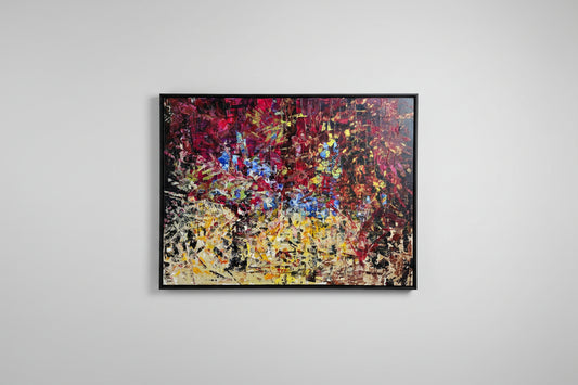 Abstract oil painting with a vibrant mix of colors on a canvas, hung on a wall.